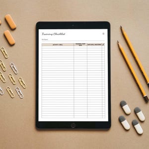 May include: A black tablet with a white screen displaying a training checklist with the title "Training Checklist". The checklist has columns for "Activity / Skill", "Training Start Date", and "Date Skill Mastered".