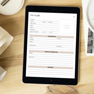 May include: A digital tablet displaying a pet profile form with sections for pet name, date of birth, breed, weight, coat color, vet information, medical information, and markings. The form has a space for a photo of the pet.