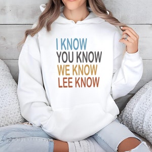 May include: White hooded sweatshirt with the text "I know you know we know Lee know" in colourful retro font.