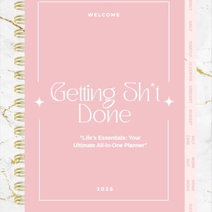 May include: A pink planner with gold spiral binding. The cover reads "Getting Sh*t Done" with the text "Life's Essentials: Your Ultimate All-In-One Planner" and the year 2025. The planner has tabs for weekly, daily, and other categories.