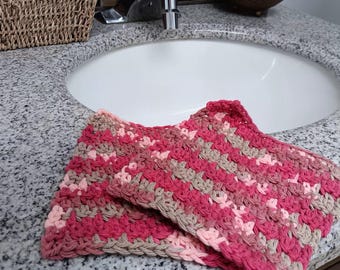 Pair of washcloths made of cotton in pink or purple tones