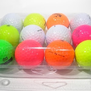 May include: A clear plastic container holding a dozen golf balls in various bright colors: white, yellow, orange, pink, green, and red. The golf balls have dimpled surfaces and some have printed markings.