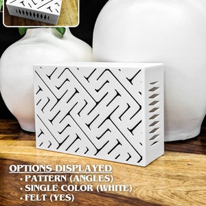 May include: White box with a geometric pattern cut out design. The pattern is made of angles. The box is made of felt.