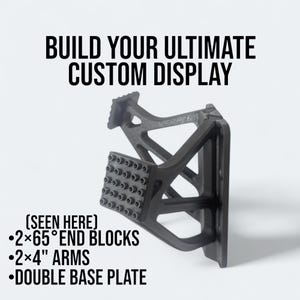 May include: A black custom display component with the text "BUILD YOUR ULTIMATE CUSTOM DISPLAY." The image shows 2x4" arms, 2x65&deg; end blocks, and a double base plate.