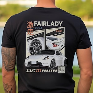 May include: Black t-shirt with a white Nissan Fairlady Z34 printed on the back. The design features the car in a retro style with the text "Fairlady 370Z 2021" and Japanese characters.