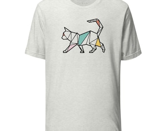 May include: Light gray t-shirt featuring a geometric cat design in black outline with pink, teal, yellow, and orange accents. The shirt has a crew neck and short sleeves. The brand name "kolala" is printed on the collar.