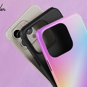 a close-up view of a smartphone with a colorful case, set against a pink background.