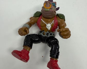 Figura de acción vintage de Bebop de las Tortugas Ninja de Playmates, de 1988.