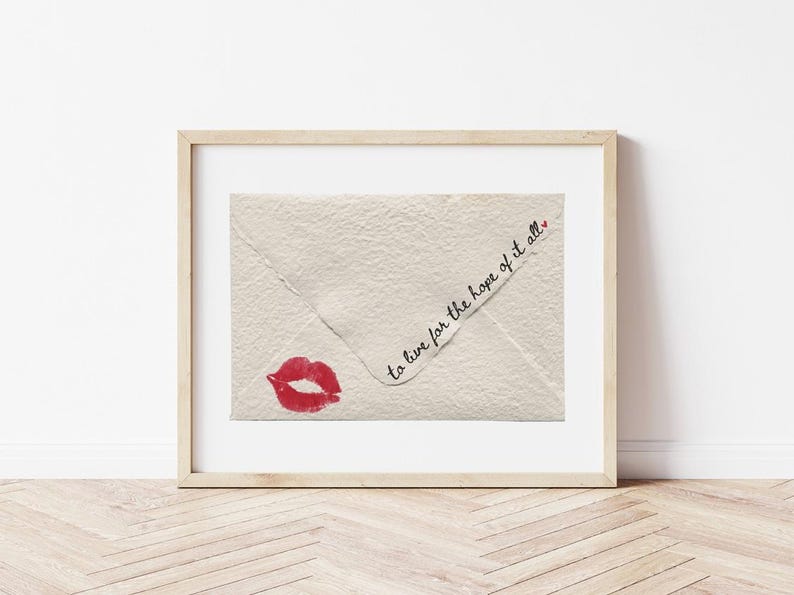 May include: A framed print of a white envelope with a red lipstick kiss and the text "to live for the hope of it all."