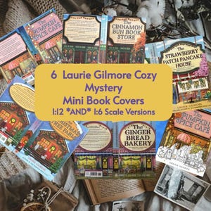 May include: Six miniature book covers from the "Laurie Gilmore Cozy Mystery" series are displayed. The covers depict charming shops and cafes, such as "The Cinnamon Bun Book Store" and "The Strawberry Patch Pancake House." The text on the covers reads "1:12 *AND* 1:6 Scale Versions."