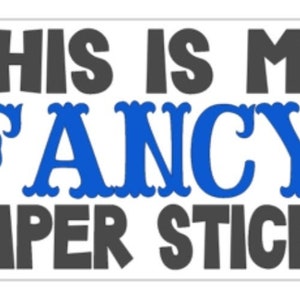 May include: A white bumper sticker with the text "This is my FANCY bumper sticker" in black and blue lettering.