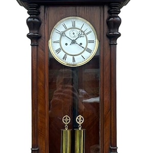 May include: Antique wooden wall clock with a horse sculpture on top, a Roman numeral clock face, and a glass door revealing the clock's inner workings.