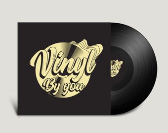 May include: A black square vinyl record jacket featuring a gold circular graphic with the text Vinyl By you in a stylized script font. Beside the jacket is a black vinyl record with a matching gold circular label displaying the same text.