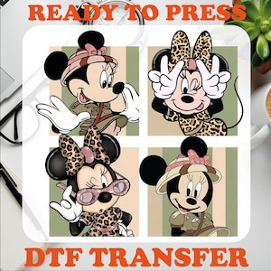 May include: Four different designs of Minnie Mouse in a safari theme. Each design features Minnie Mouse wearing a safari hat and a leopard print outfit. The designs are ready to press for use on t-shirts, bags, and other items.