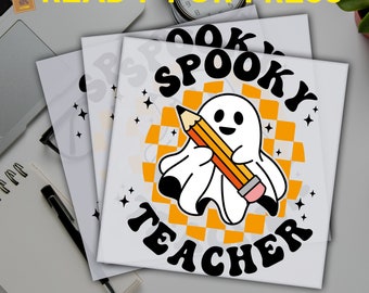 May include: DTF transfers featuring a cartoon ghost holding a pencil, with the text "Spooky Teacher." The design includes an orange and white checkered background and stars. The words "Ready for Press" and "DTF Transfers" are also visible.