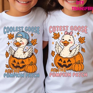 May include: White t-shirts with matching graphics. One shirt features a cartoon goose wearing a blue cap, the text "Coolest Goose", and a pumpkin. The other shirt has a goose with a pink bow, the text "Cutest Goose", and a pumpkin. Both say "At the Pumpkin Patch".