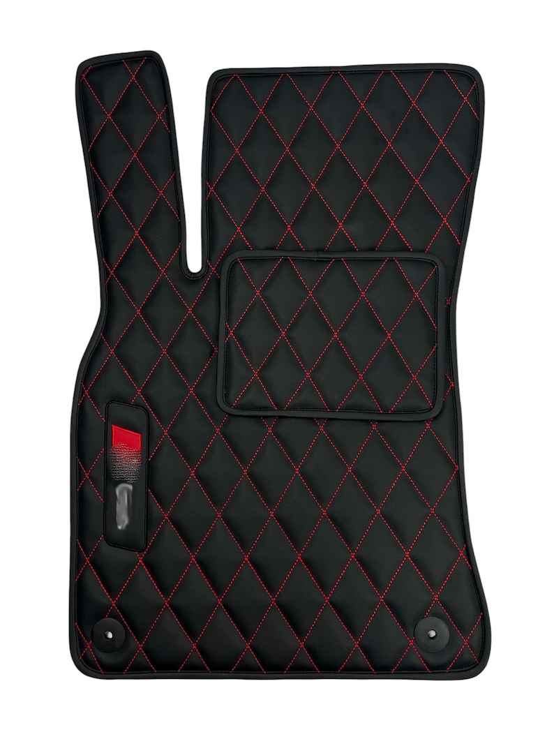 May include: Black car floor mats with red diamond stitching. The mats have a small pocket on the driver's side and a logo on the passenger's side.