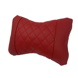 May include: Red quilted neck pillow with diamond stitching.