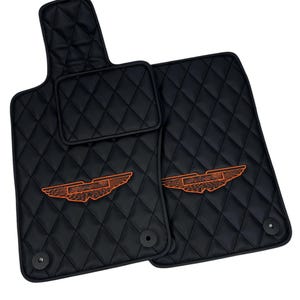 May include: Black leather car floor mats with a diamond pattern and orange embroidered wings logo.