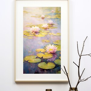 May include: A framed painting of pink water lilies in a pond with green lily pads. The painting is in a light wood frame and is hanging on a white wall.