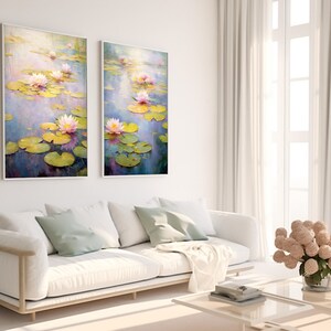 May include: Two framed paintings of water lilies in a pond. The paintings are in a light blue and purple color scheme with green lily pads and pink flowers.
