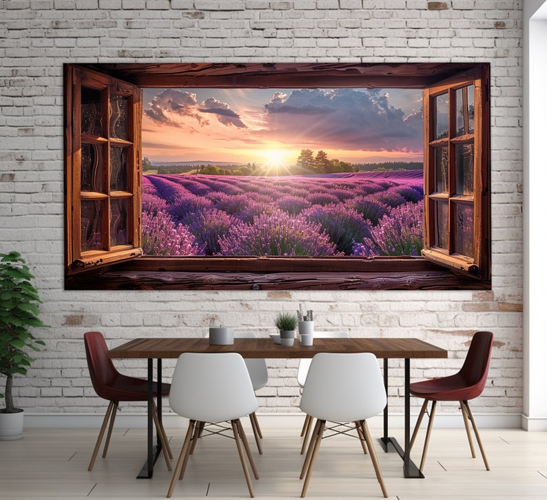 May include: A framed canvas print of a window looking out onto a field of lavender flowers. The sun is setting behind the flowers, creating a warm glow. The window is open, and the frame is made of wood.