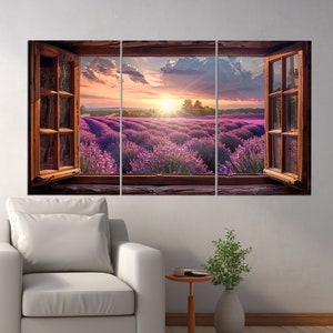 May include: A three-panel canvas print depicting a view of a lavender field through an open window. The field is bathed in the golden light of a setting sun, with fluffy clouds in the sky. The window frame is made of weathered wood.