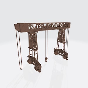 May include: A brown model of a gantry crane. The crane has a rectangular top with a lattice design, supported by two vertical towers. Each tower has a set of wheels at the base. Hooks and cables hang from the crane.