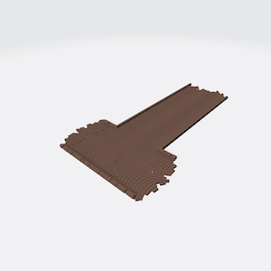 May include: A brown T-shaped track piece with a textured surface featuring a repeating pattern of curved, parallel lines. The object has a flat, elongated design with a wider section at one end and a narrower, straight extension at the other.