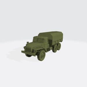 May include: A green military truck model with a covered cargo bed. The truck has a detailed front grille, headlights, and large off-road tyres. The model is a solid colour and appears to be made of plastic or resin.