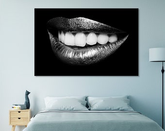 May include: A black and white photograph of a close-up of a woman's mouth with silver lipstick. The lips are slightly parted, revealing a row of white teeth.