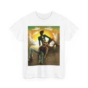 Puede incluir: Camiseta blanca con una ilustración de dos figuras en un atardecer. Una figura lleva una chaqueta verde, la otra una camiseta sin mangas negra. La obra de arte tiene una paleta de colores cálidos.