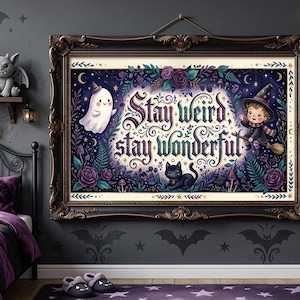 May include: A framed artwork with the text "Stay Weird Stay Wonderful" in a gothic-style bedroom. The artwork features a ghost, witch, and black cat. The room has a black bed frame, purple bedding, and a skull lamp.