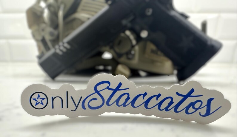 May include: A white sticker with blue text that reads "Only Staccatos" with a star in a circle on the left side.