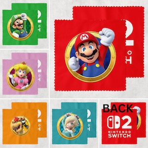 May include: Colorful microfiber cleaning cloths featuring characters from the Super Mario video game series. The cloths are green, red, pink, orange, and teal, with images of Mario, Luigi, Princess Peach, Bowser, and Rosalina. The back of one cloth has the text "BACK Nintendo Switch".