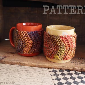 Puede incluir: Dos tazas con fundas de punto coloridas. Una taza es naranja, la otra es amarilla. Las fundas están hechas de hilo en tonos naranja, amarillo, morado y marrón. La palabra "PATTERN" está en la parte superior de la imagen.