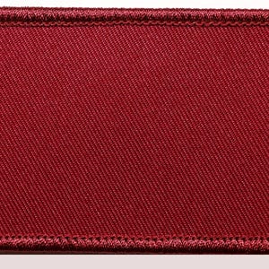 May include: A rectangular patch in a deep burgundy color. The patch has a woven texture and a stitched border. The edges are neatly finished with a matching thread, creating a clean and professional look. This patch could be used for various applications.