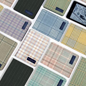 May include: A collection of various patterned tablet cases, featuring a range of colors including blue, yellow, green, and pink. Each case has a rectangular shape and a small, dark blue label with white text. One case displays a tablet screen.