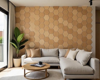 May include: A light gray sectional sofa with a wooden frame and a light brown hexagonal tile wall behind it. The sofa has a few throw pillows and a coffee table with a book and a mug on it.