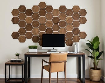 May include: A modern home office with a wooden desk and chair. The wall behind the desk is decorated with a honeycomb pattern of wooden tiles. A computer monitor, a potted plant, and books are on the desk.