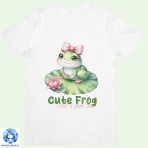 May include: White t-shirt with a green frog wearing a pink bow sitting on a green lily pad with a pink flower. The text "Cute Frog with a pink bow" is printed below the frog.