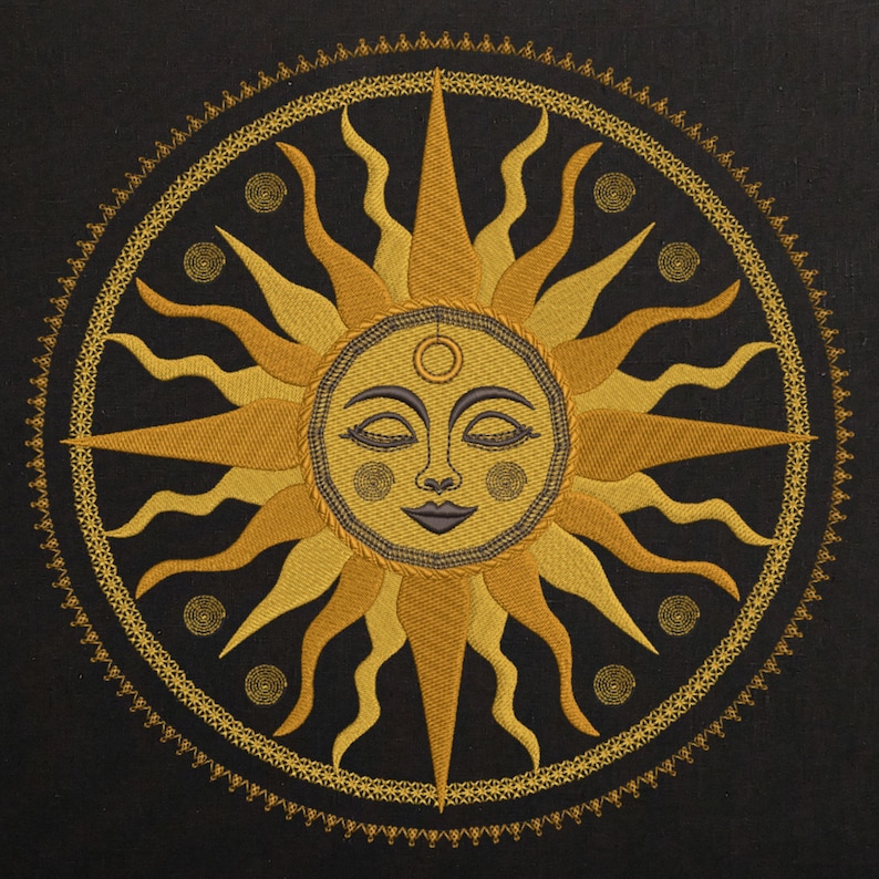 May include: Embroidered sun design in shades of gold and yellow on a black background. The sun has a smiling face with closed eyes and a third eye. A decorative border surrounds the sun, with spiral accents.