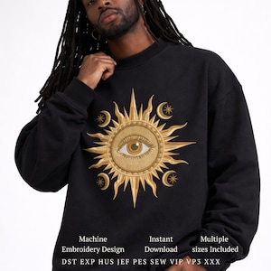 May include: Black sweatshirt featuring a golden sun design with an eye at the center, surrounded by crescent moons and stars. The text "Machine Embroidery Design" and "Instant Download" are visible at the bottom. Multiple sizes are included.