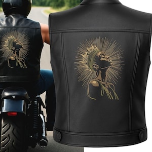May include: Black leather vest with a gold illustration of a woman and a sunburst design. The vest has a classic biker style with a collar and a tailored fit. The image shows the back of the vest, highlighting the artwork.