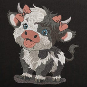 May include: Embroidered design of a cute cartoon cow with black and white spots, wearing pink bows. The cow has a pink nose and tongue sticking out.