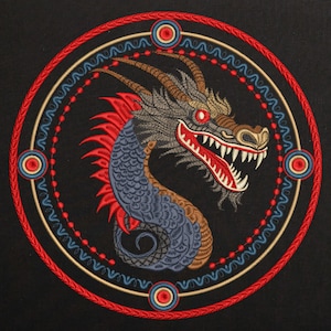 May include: Embroidered design of a blue and brown dragon with red accents, set within a circular frame with red, gold, and blue details.