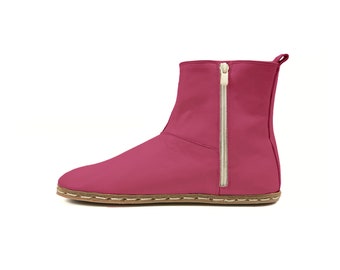 May include: A magenta-colored ankle boot with a side zipper and a stitched sole. The boot has a rounded toe and a pull tab at the top. The zipper is a light gold color.