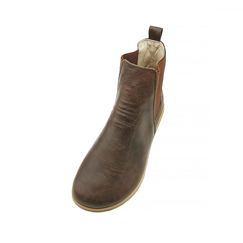 May include: Brown leather ankle boots with a pull-on design and elastic side panels.