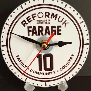 May include: A round clock with a white face and brown rim. The clock face features the words "REFORMUK FARAGE" and "MADE IN BRITAIN". The clock hands are black, with a red second hand. The number 10 is prominently displayed.