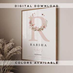 May include: A framed digital download print featuring a large, blush-colored letter "R" adorned with a floral wreath. The name "RABIHA" is displayed below the letter, with Arabic script and the meaning "SUCCESSFUL | VICTORIOUS". The words "DIGITAL DOWNLOAD" and "COLORS AVAILABLE" are also visible.